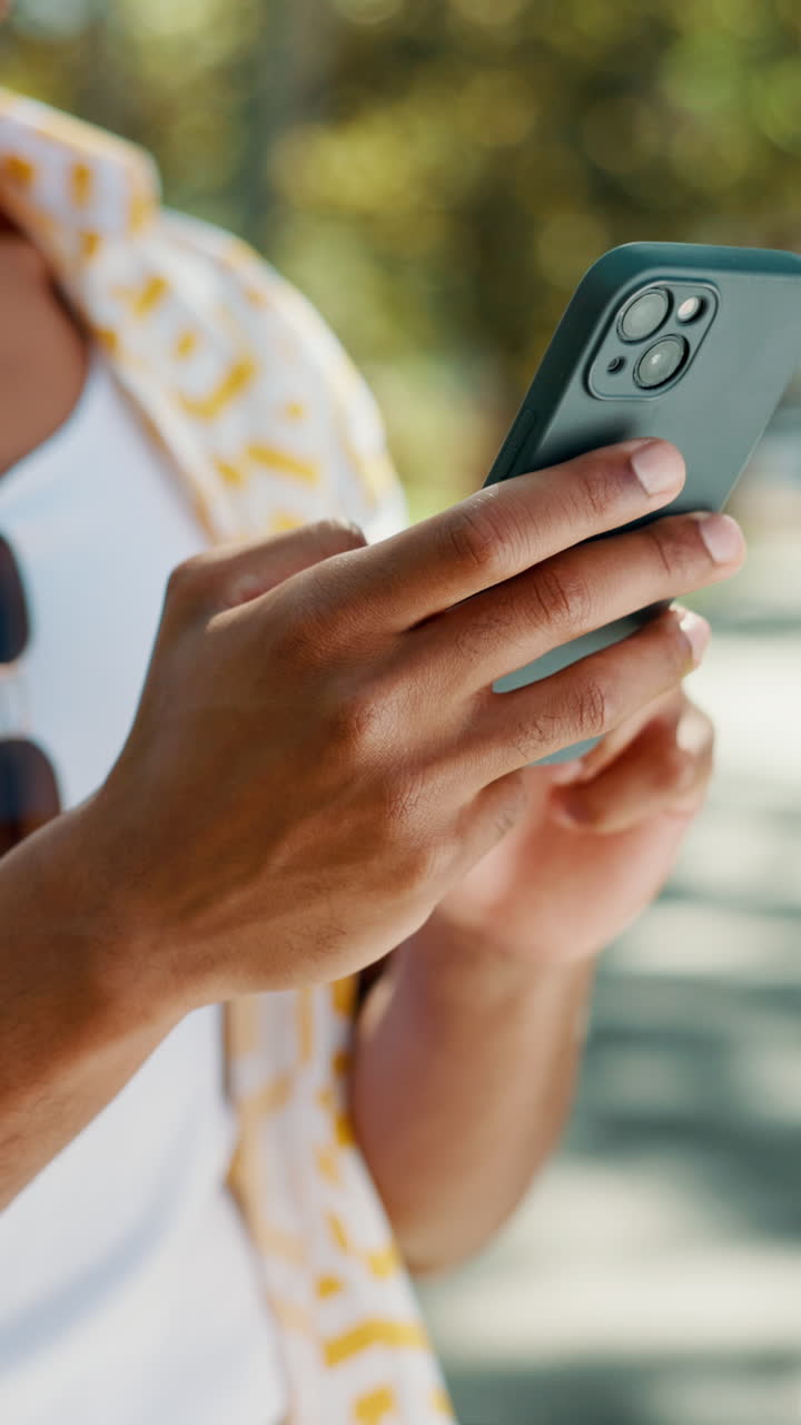 Close-Up of Person's Hands Using a Smartphone Outdoors