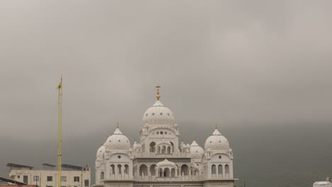 ancient holy pilgrimage city pushkar temple sahib gurudwara moody clouds, copy space