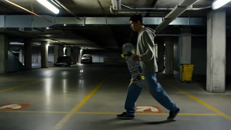 young man preparing to skateboard in an underground parking lot