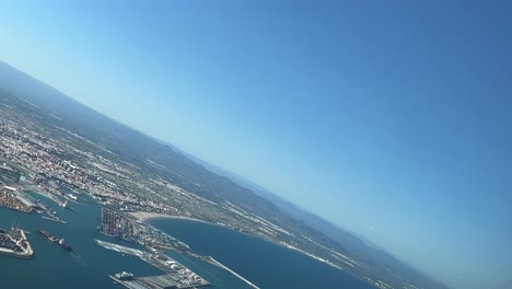 panoramic aerial view of valencia city and harbor, spain, shot from a jet cabin during the approach to the airpoprt during a splendid summer day