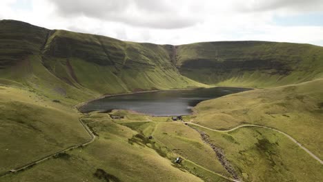 llyn y fan fach beautiful brecon beacons mountain lake scenic valley countryside aerial view landscape wide orbit right