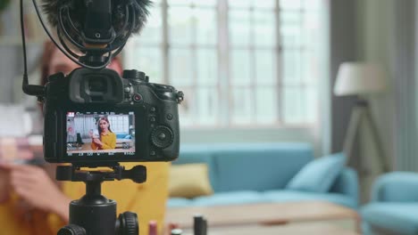 display of camera recording video blog tells how to be beautiful in home studio. influencer young transgender woman blogger talks about makeup