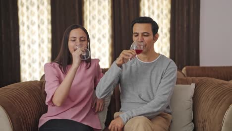pareja india feliz bebiendo vino en una cita