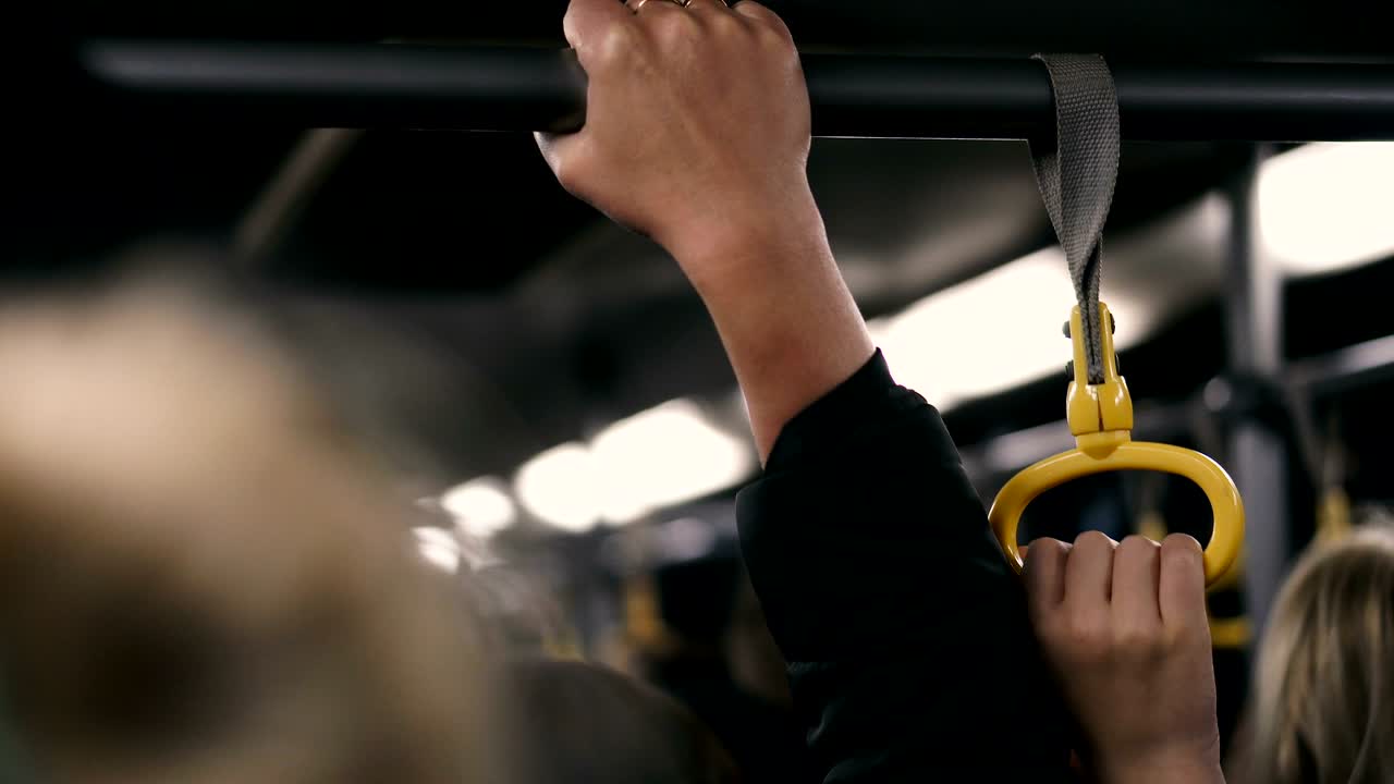 Hands holding a pyril in the cabin of the bus