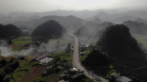 plataforma rodante aérea sobre una carretera de pueblo rodeada de montañas y campos, ha giang, vietnam