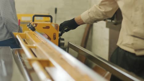 worker cuts a stainless sheet with special equipment