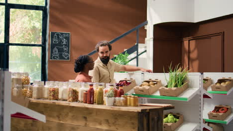 merchant shows fresh produce to people