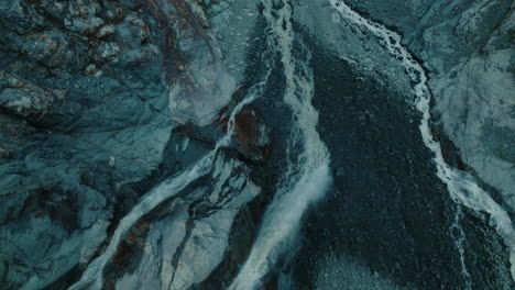 glacier melting in a lake below due to climate change in the alps, view from above