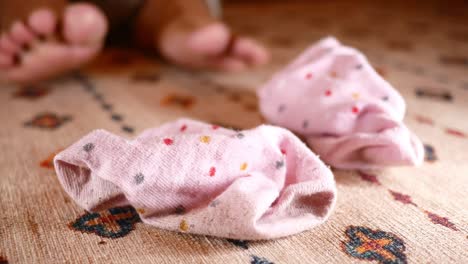 pink dotted socks on carpet