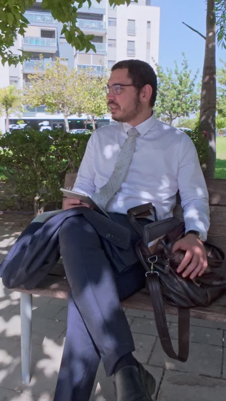 Man in Suit Sitting on Park Bench