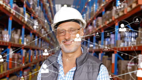 Animation-of-network-of-connections-with-icons-over-caucasian-man-working-in-warehouse