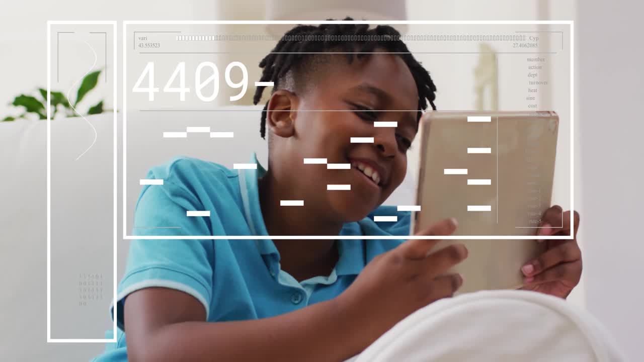 Boy tapping tablet initiating semi-transparent overlay showing changing data codes for tech demo