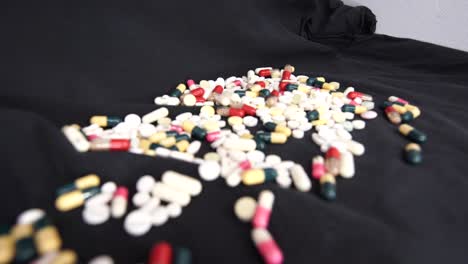 pills fall on a dark background