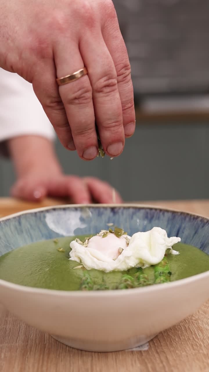 Chef Preparing Green Soup with Poached Egg and Asparagus