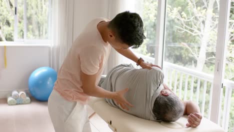 montage of diverse male physiotherapist and senior male patient exercising in studio, slow motion