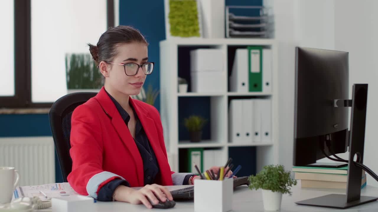 Executive assistant researching sales statistics on computer