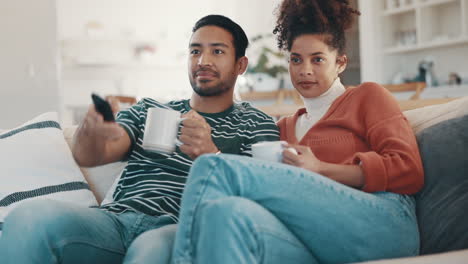 couple, watching tv and talk with coffee on sofa