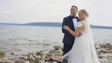 Bride-and-groom-laugh-together-on-beach