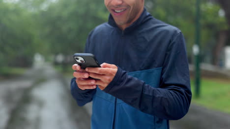 man using phone in the rain