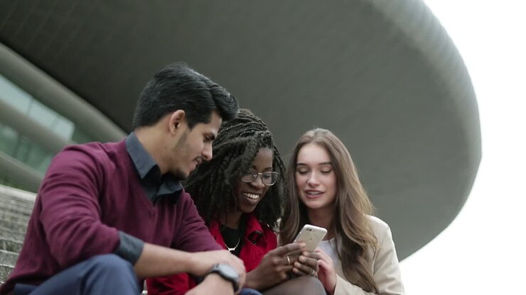 Young people googling on phone place to go, discussing