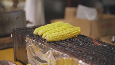 Japanese-Sweet-Corns-Being-Grilled-On-The-Griller-At-The-Street-Market-During-The-Yoiyama-Festival-At-The-Gion-Matsuri-Festival-At-Night-In-Kyoto,-Japan