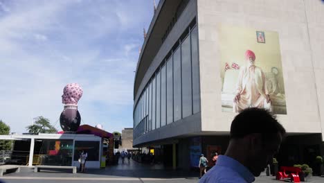 people walking by royal festival hall, london