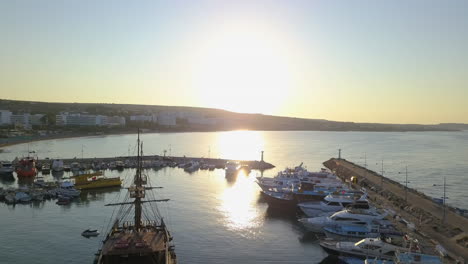 aerial shot of a small fishing and tourist harbor on the coast of a holiday resort