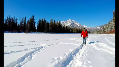 Man-walking-on-snowy-landscape-4k
