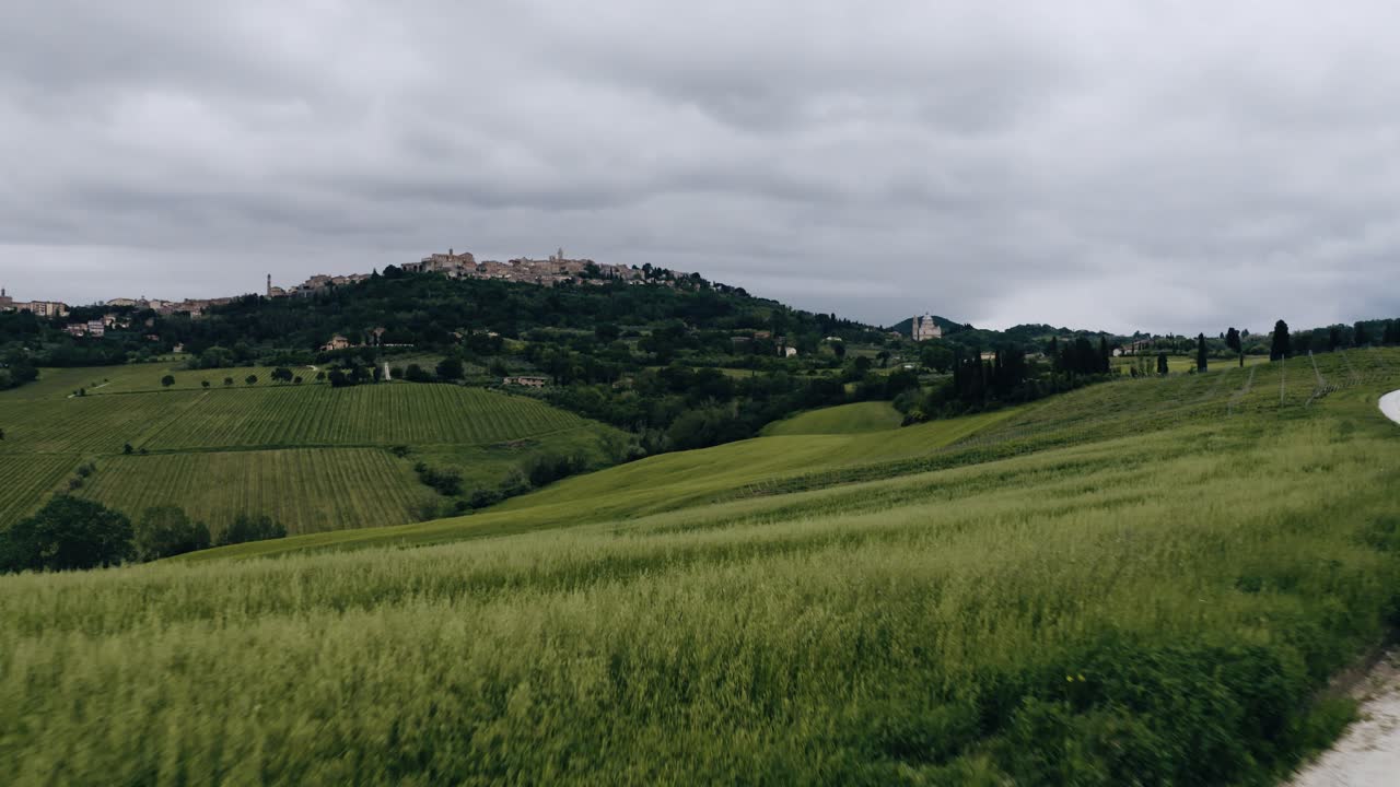Low aerial view pulling away from Italy's rural farmland