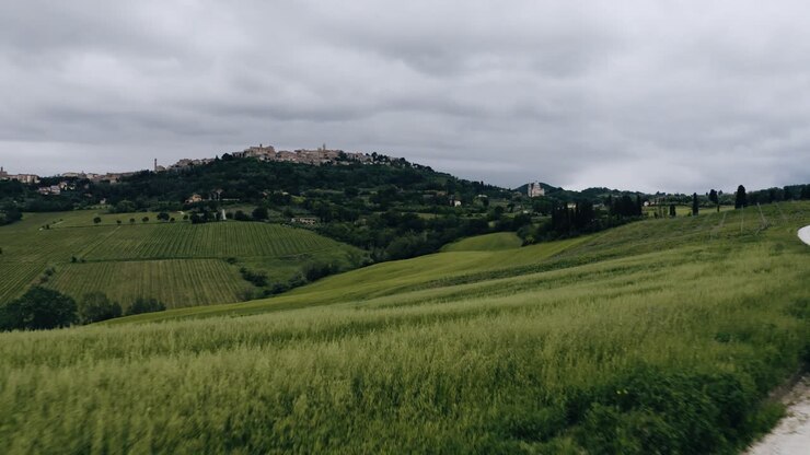 Low aerial view pulling away from Italy's rural farmland