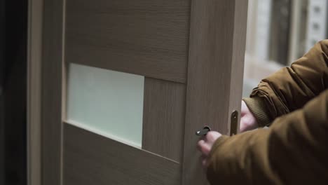 Man-in-hardware-store-choosing-a-door-checking-a-lock