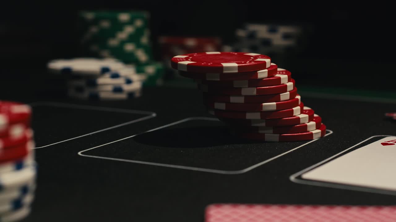 Hands managing poker chips on green table, reflecting intense poker gameplay with the element of chance and skill