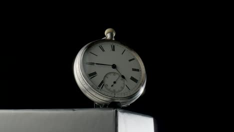 vintage pocket watch on black background