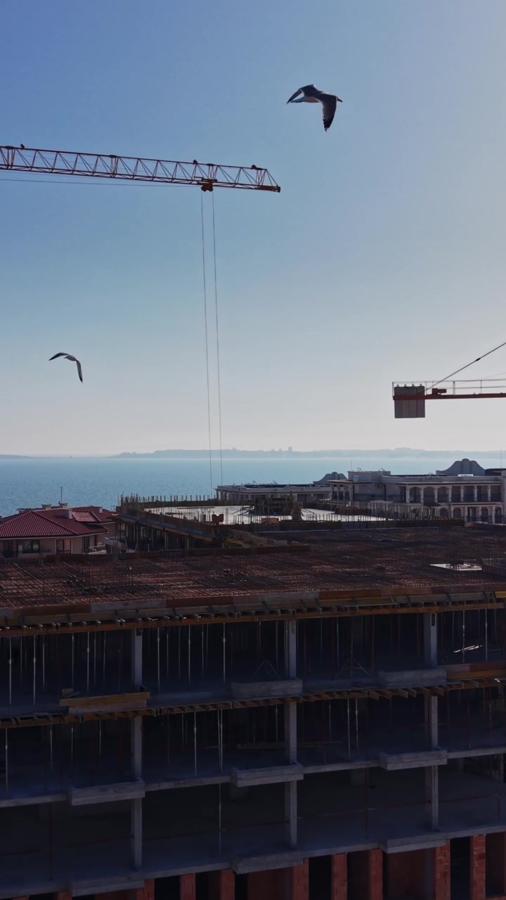 Drone view of city development and tower cranes