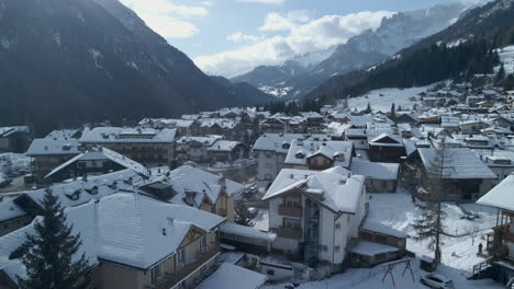 winter village in val di fassa, trentino, italy amid snowy alp mountains, scenic village in snowy trentino, italy, with mountain views and charming architecture