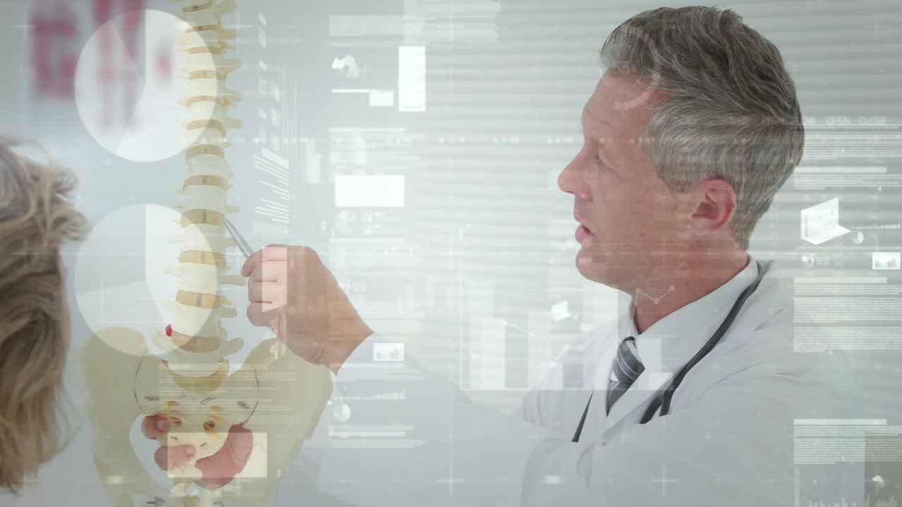 Male doctor explaining spine to patient in clinic, with floating interface graphics overlaying data