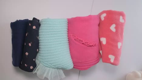 folded baby blankets and clothes