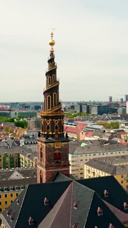 vertical elevated view of church of our saviour, showing its iconic golden spire and the urban landscape beyond.