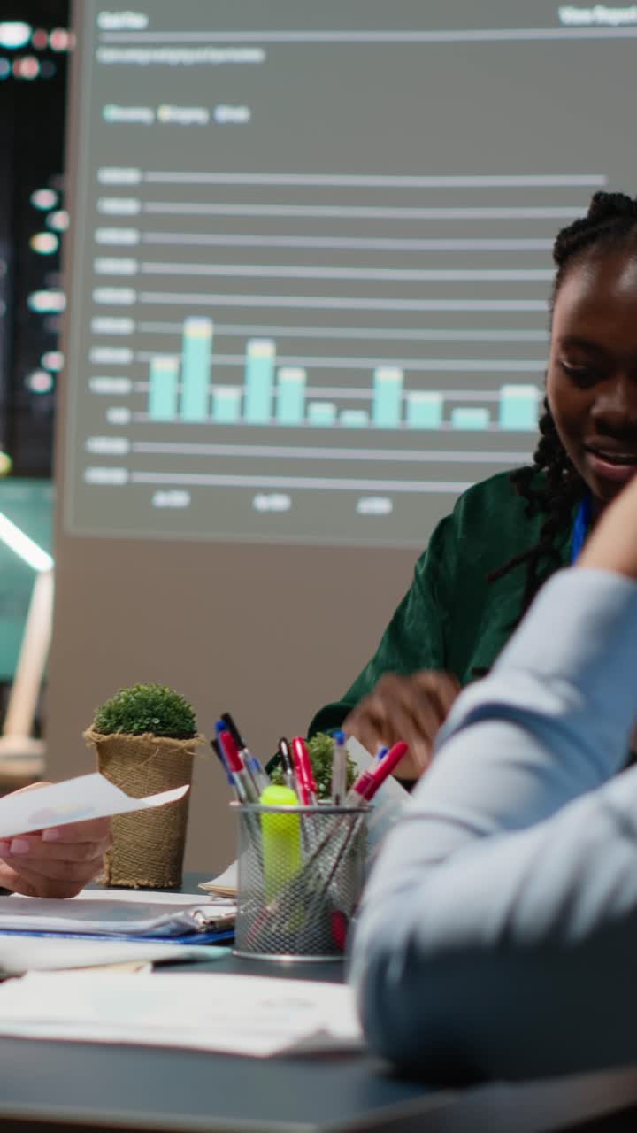 Vertical Video Close up of diverse business staff exchanging reports files and insights
