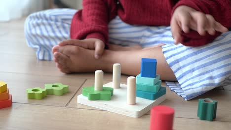 child playing with wooden blocks puzzle