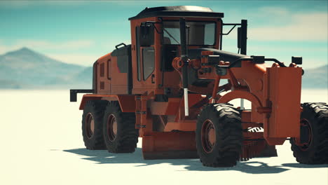 road grading machine on the salt desert road