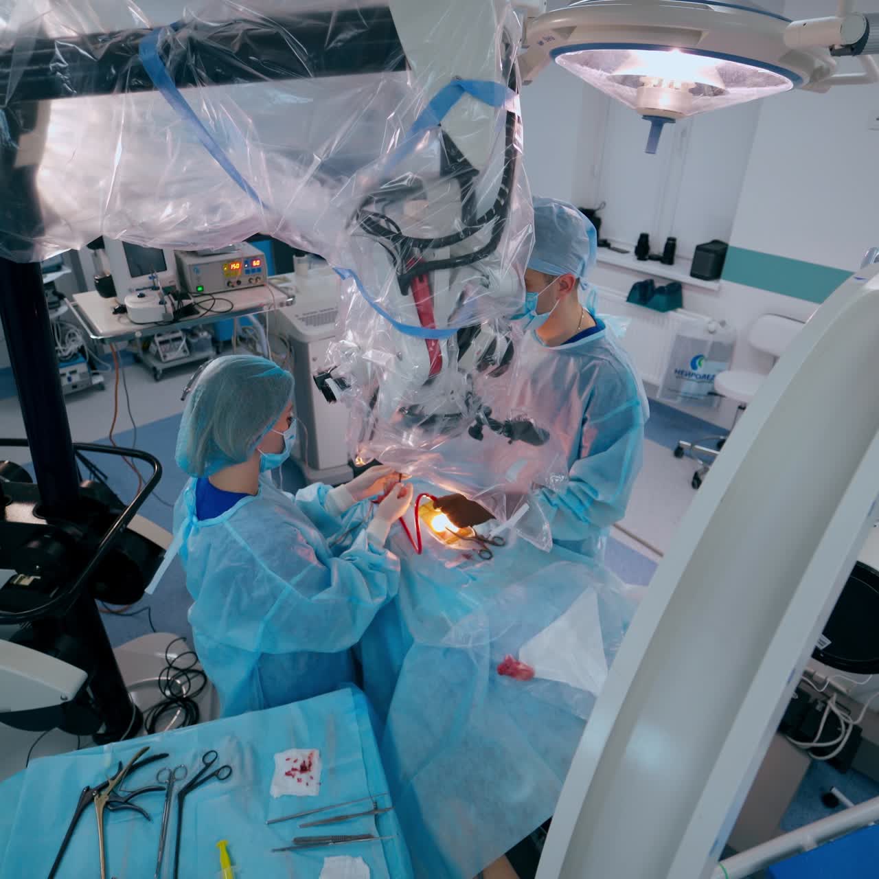 Operating process in the contemporary operating theater. Medical workers perform a surgery using new medical equipment in the hospital.