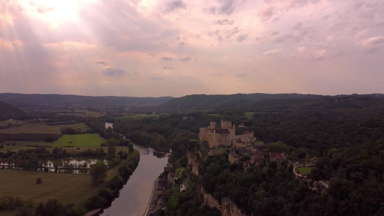 Aerial medieval castle Sunset dramatic view of Beynac-et-Cazenac in France near the dordogne river,