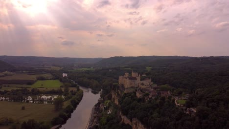 aerial medieval castle sunset dramatic view of beynac-et-cazenac in france near the dordogne river,