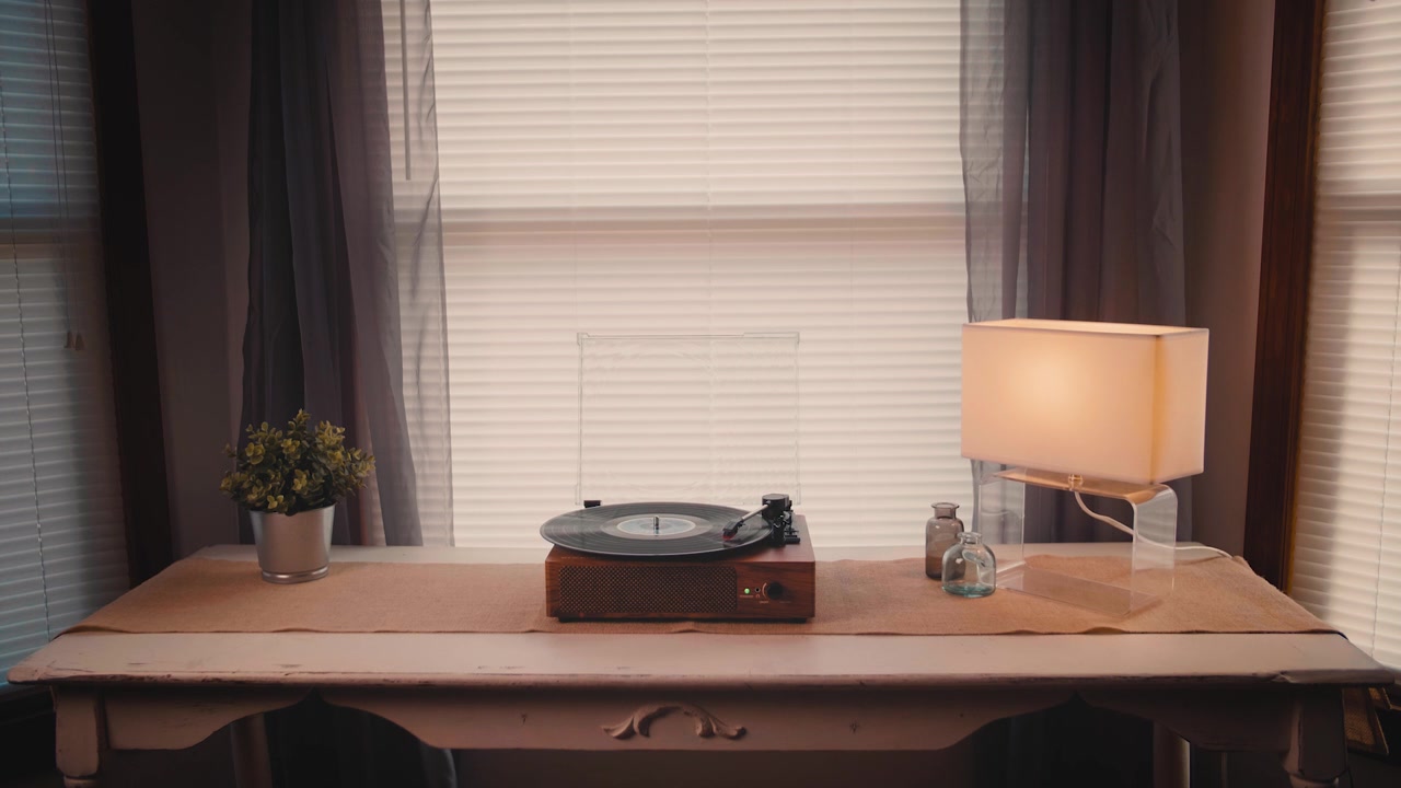 Man's Hands Playing a Vinyl Record on a Vintage Turntable