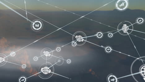animación de iconos conectados sobre vista aérea del bosque contra el cielo