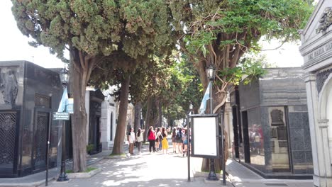 tourists walk inside history: recoleta cemetery, a landmark of buenos aires