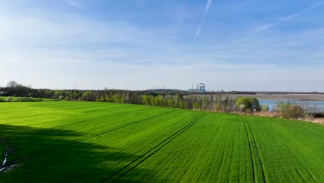 drone-approaching-konin-coal-power-station-in-Poland-flying-above-warta-river-during-sunny-day