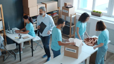 volunteers sorting donations in a charity center