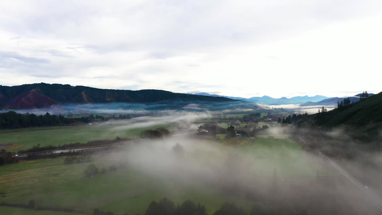 Low and slow aerial passover a misty valley